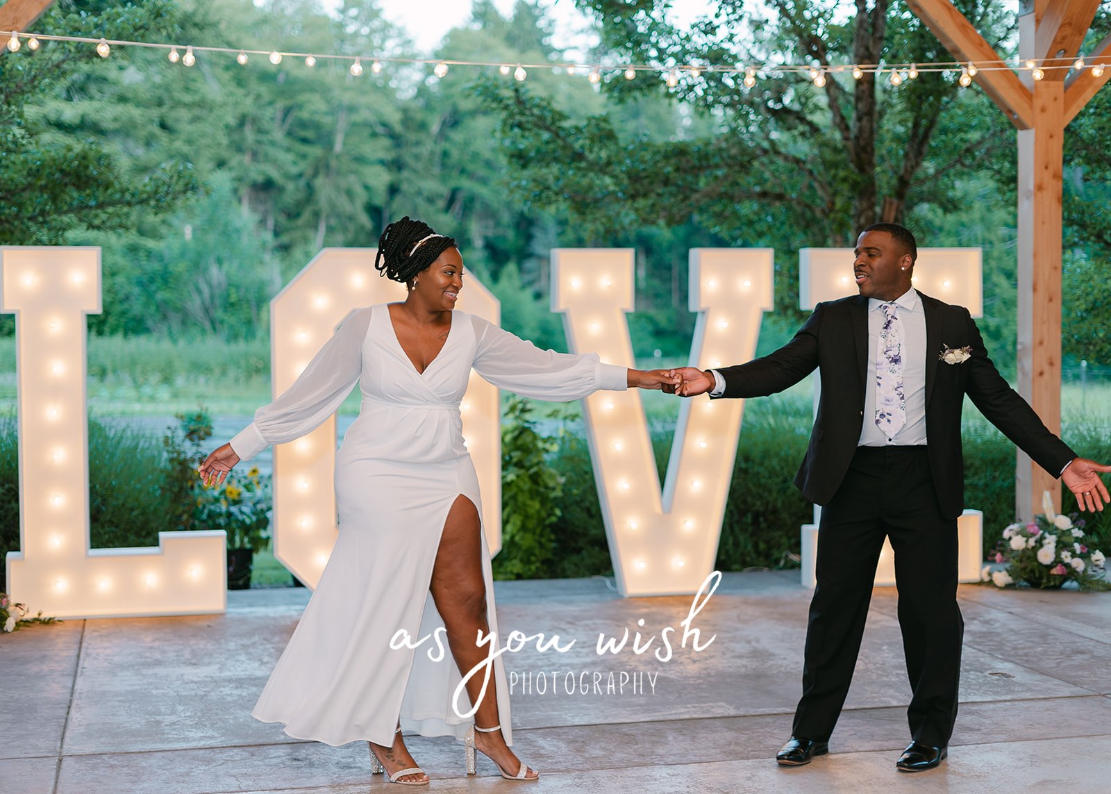 Giant LOVE letters with couple doing the first dance in front