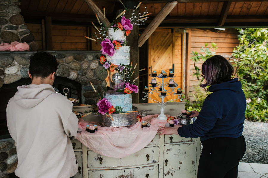 wedding cake being set and decorated by bella bella bakery