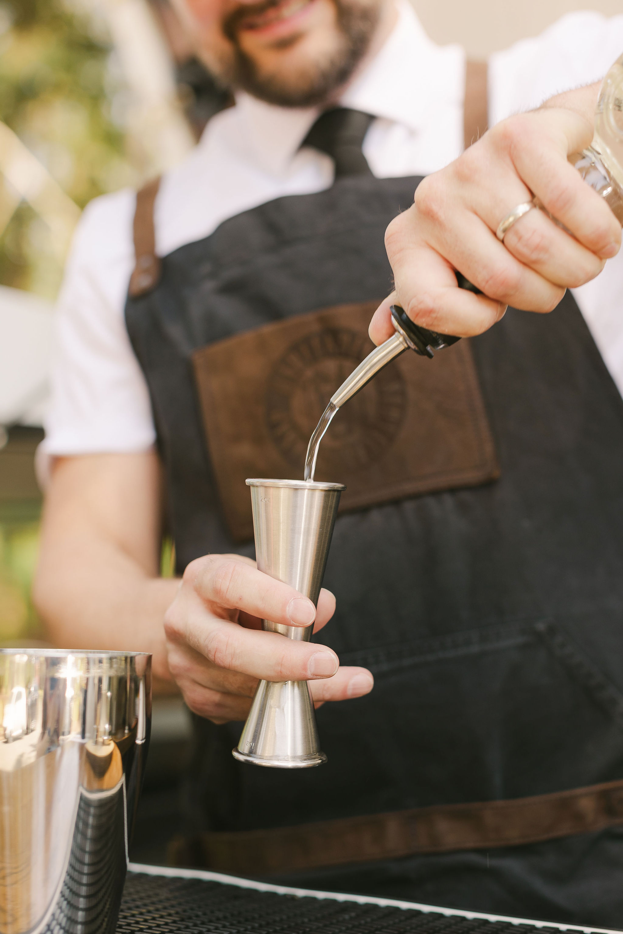 kitsap mobile bartending services - bartender using a metal, japanese style jigger