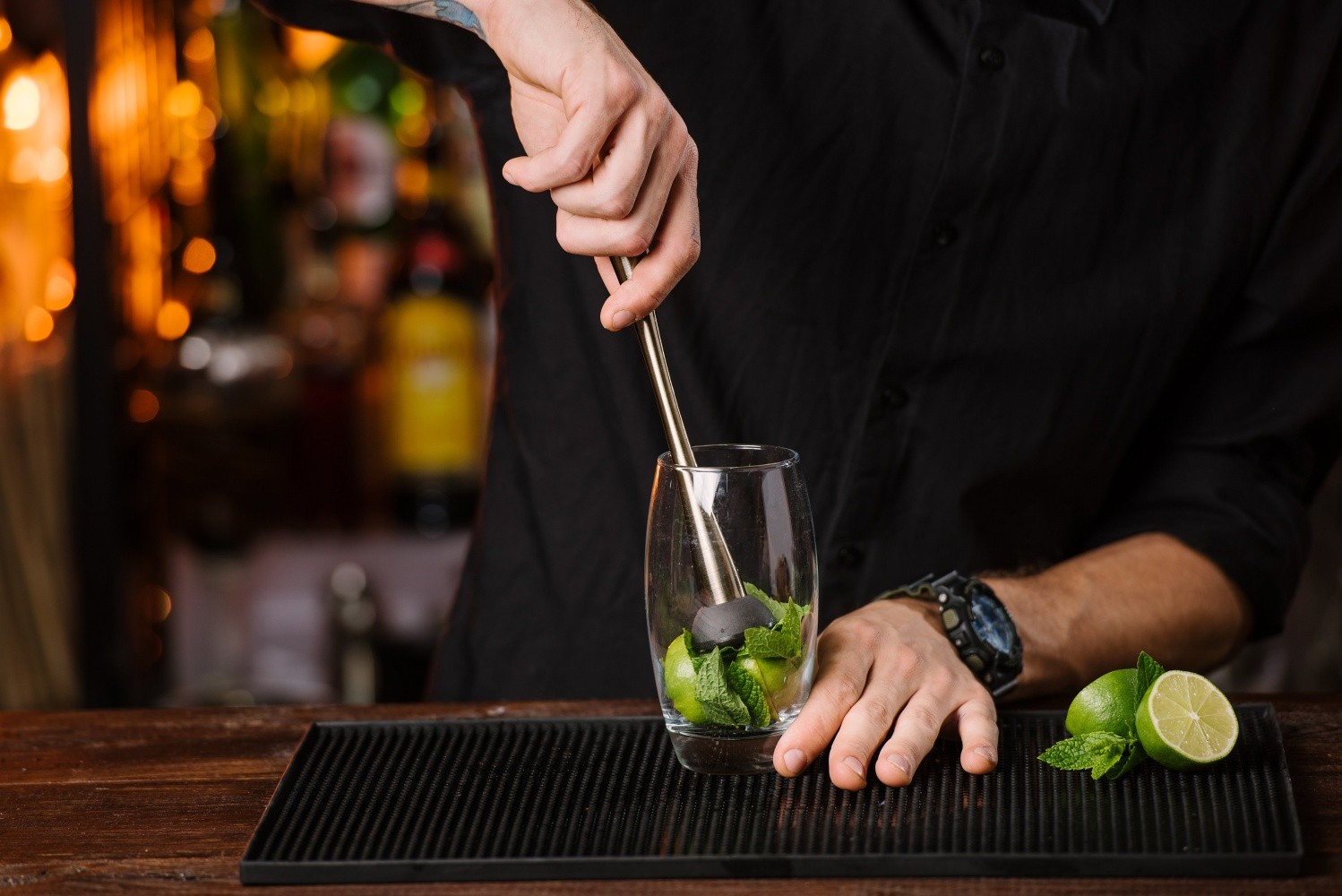 bartender using a muddler