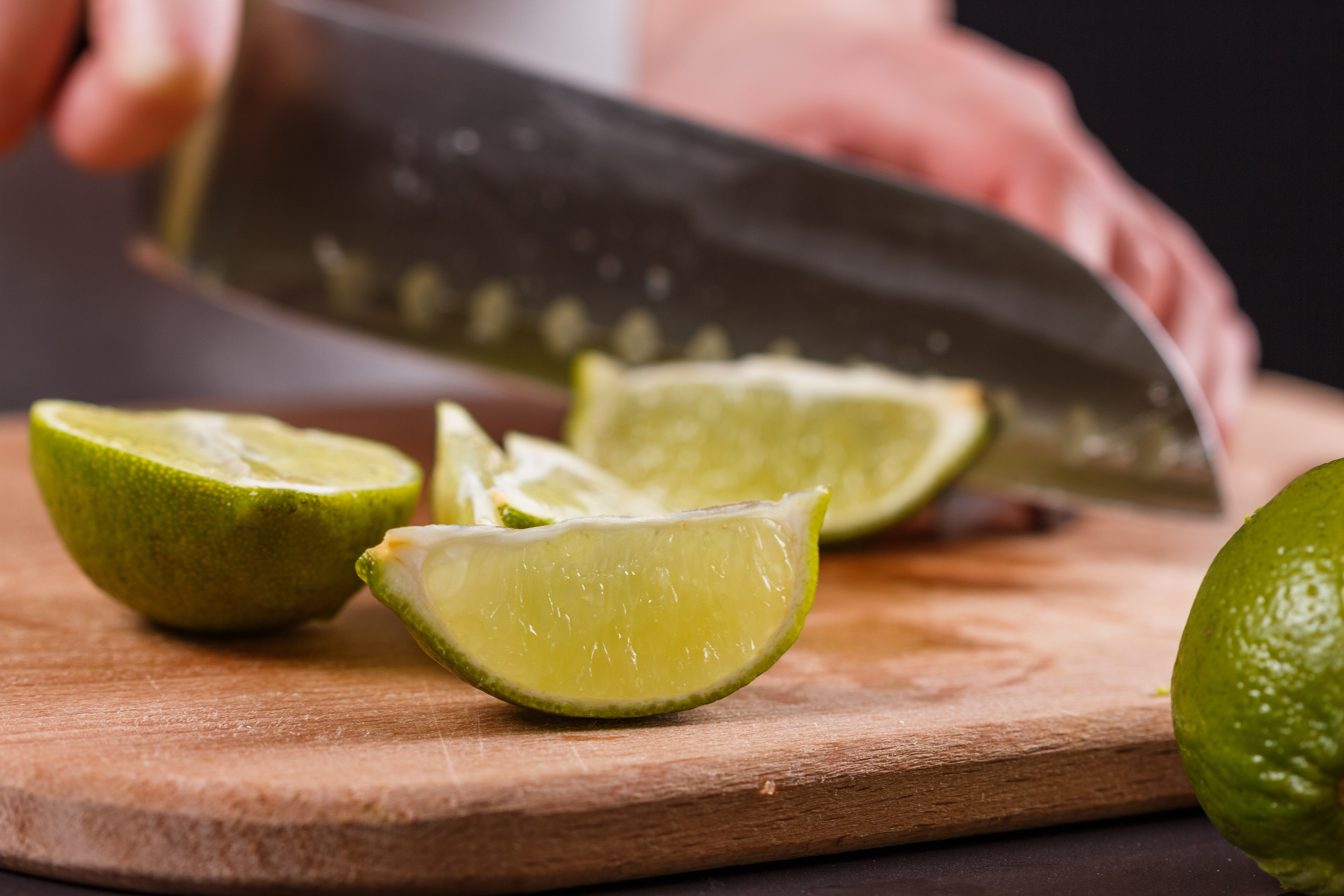 mobile bartender for hire in kitsap county using a knife and cutting board to slice fruit
