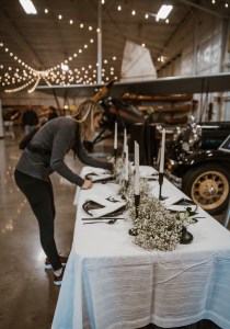 table being set by LG events from seattle - placing the florals and candles in front of a vintage car