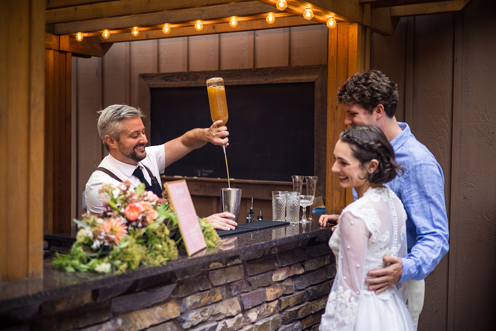 mobile bartender pouring a couple a drink at a wedding venue in Bellingham, Whatcom County - with smiles on their faces
