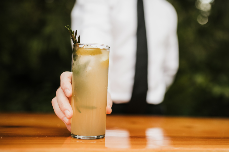 bartender holding a signature cocktail
