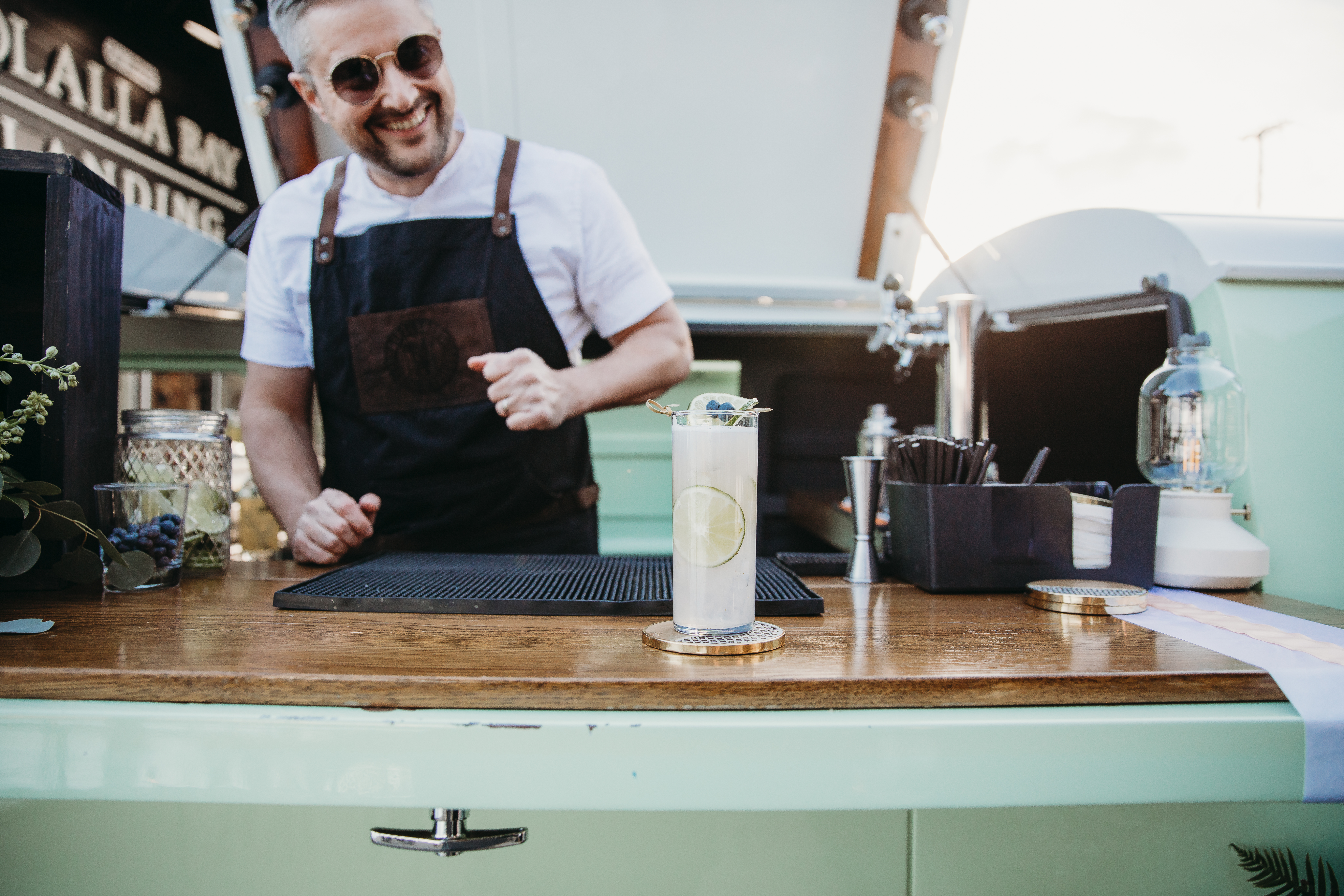bartender making a blueberry mojito using seasonal blueberries and fresh mint