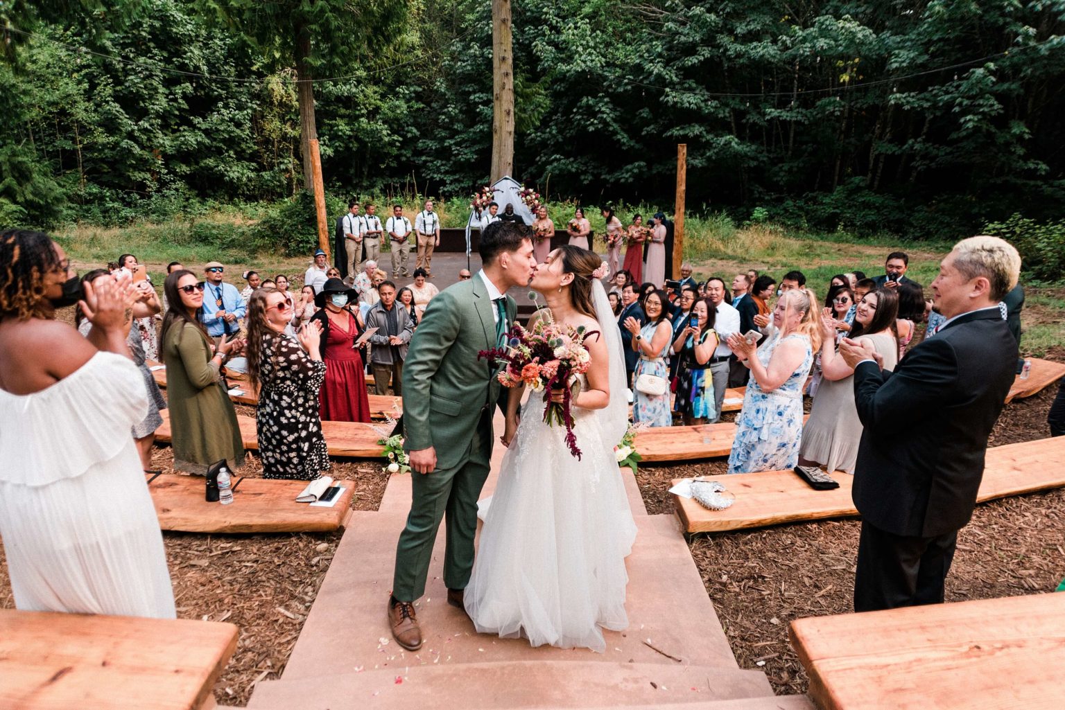 kissing couple in front of the amphitheater seating at Misty Clover Farm