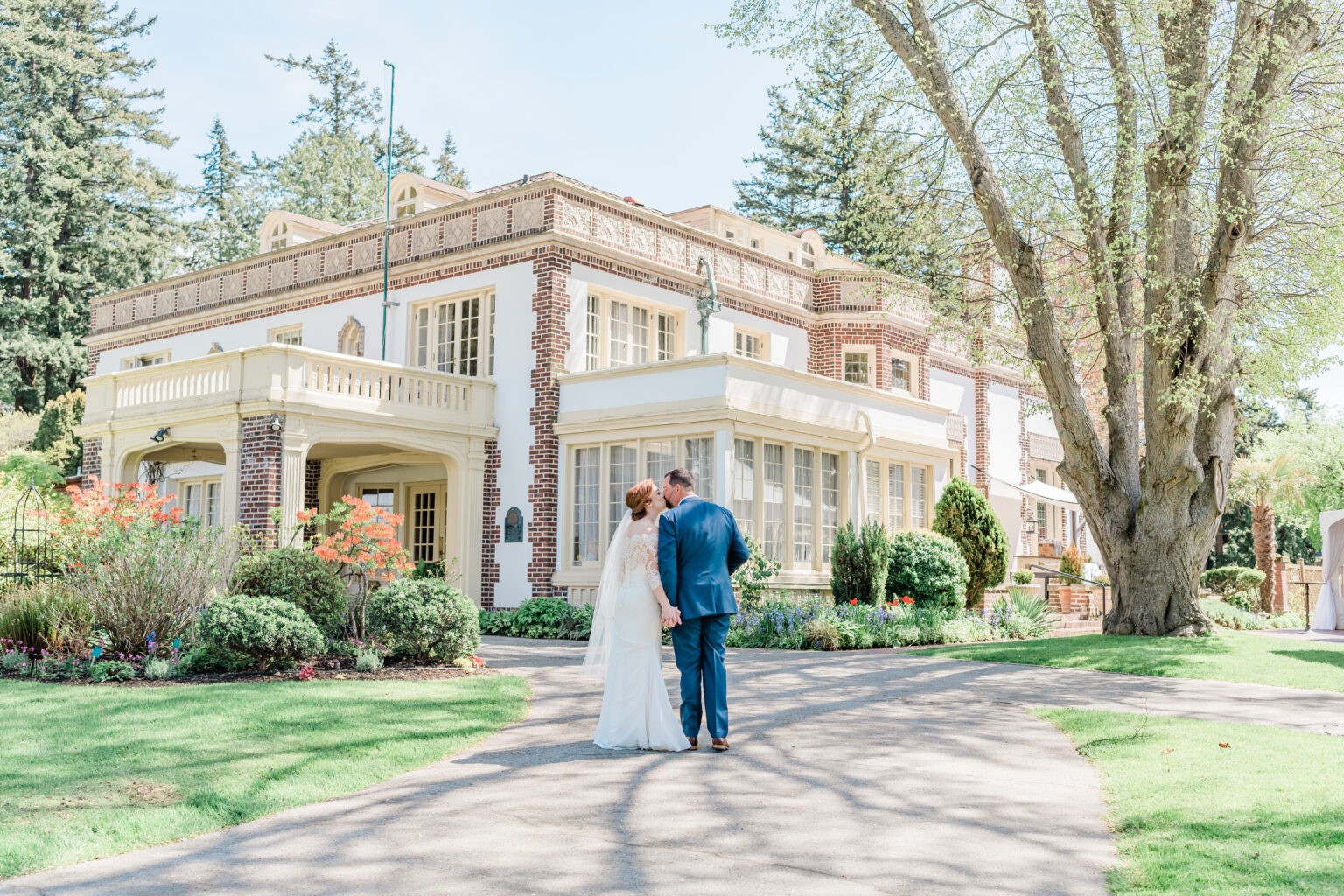 photo of couple in kissing in front of lairmont manor in bellingham washington - photo by B. Jones Photography and designed by Evergreen Weddings