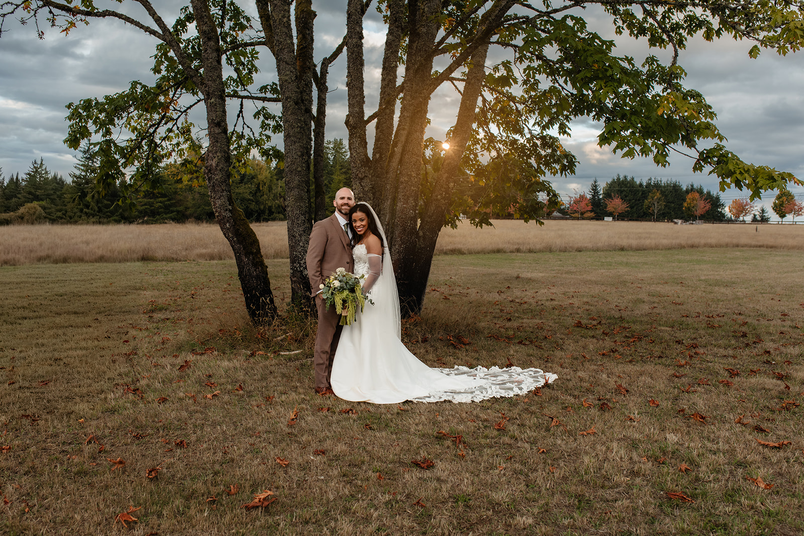 couple standing in an open field at foxglove lodge on vashon island